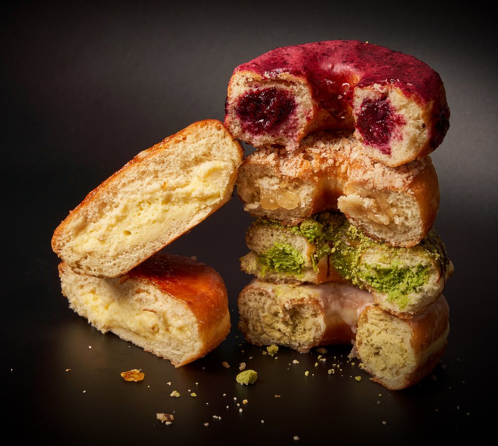 Our handmade donuts cut in half to show the fillings inside — berry, apple crumble, matcha and custard